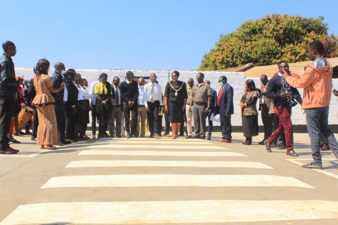 kitwe mayor mwaya crosses the newly installed zebra crossing at chimwemwe secondary school